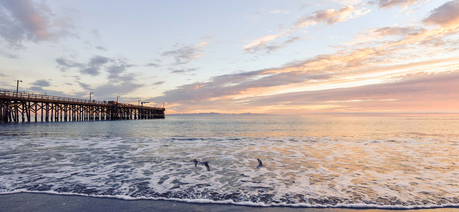 long pier reaching out into sunset